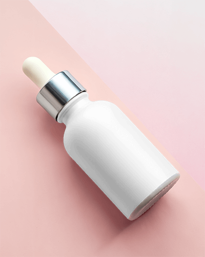 Soft Pink Dropper Bottle Mockup On Angled Surface With Subtle Lighting And Modern Minimalist Style