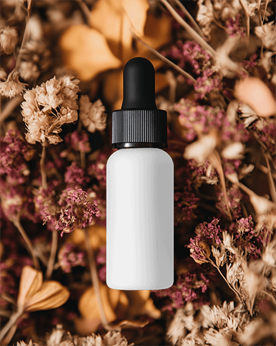 Autumn Themed Dropper Bottle Mockup Surrounded By Dried Flowers For Cozy Warm Product Presentation