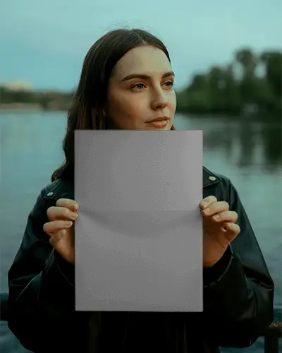 woman-holding-blank-flyer-mockup-outdoor-lake-background
