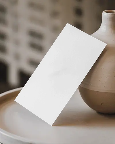 Minimalist Tabletop Flyer Mockup Angled White Card Leaning On Ceramic Vase Soft Neutral Lighting Modern Aesthetic 0110