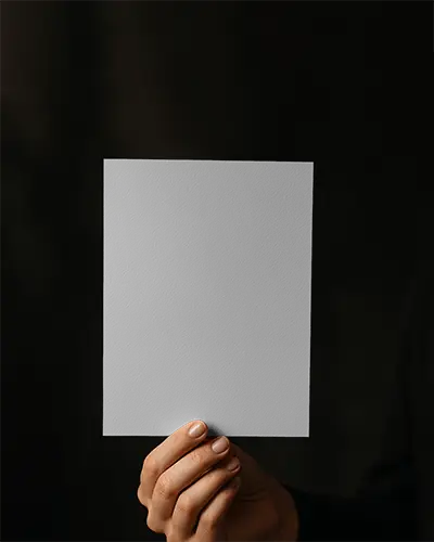 Hand Holding Portrait Flyer Mockup On Dark Backdrop With Human Touch Detail