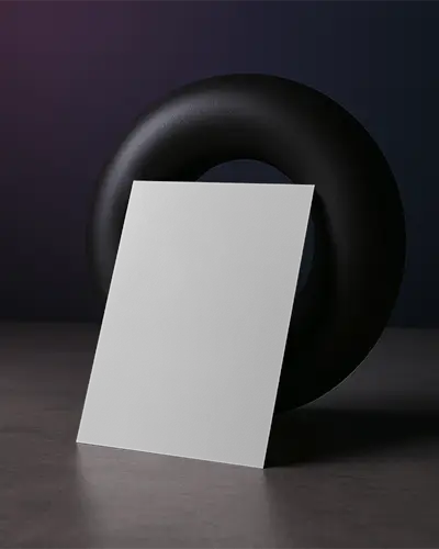 Moody Editorial Flyer Mockup Leaning Against Black Sculptural Ring On Concrete Surface With Dark Purple Light