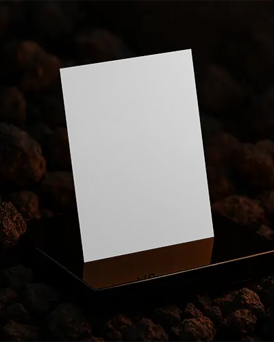 Standing Flyer Mockup On Metallic Base Against Volcanic Rock Surface With Warm Glow And Deep Texture