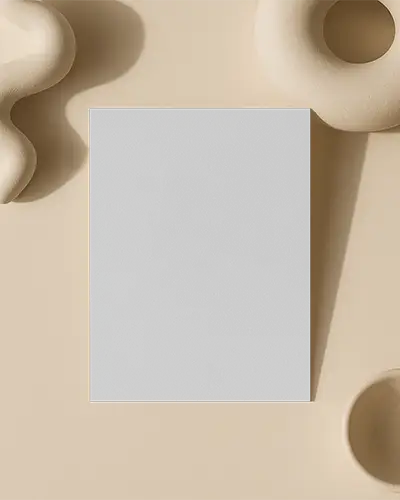 Top View Flyer Mockup On Beige Background With Minimal Organic Sculptures And Soft Shadow Play