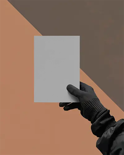 hand-holding-blank-flyer-mockup-against-geometric-background-for-design-display-0365