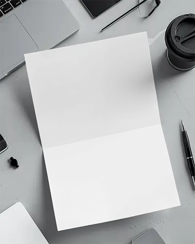 Folded Flyer Mockup On Gray Desk With Laptop Coffee Cup Pen And Smartphone Modern Office Workspace Setup 073