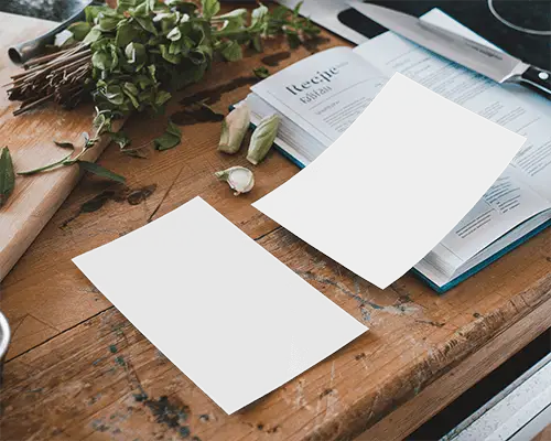 Rustic Kitchen Flyer Mockup On Wooden Countertop With Recipe Book Fresh Herbs And Knife Cozy Homestyle Cooking Atmosphere 085