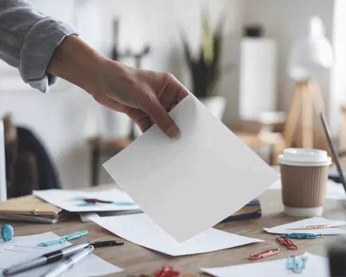 Hand Held Flyer Mockup On Cluttered Desktop Creative Workspace With Paperclips And Coffee Cup 088