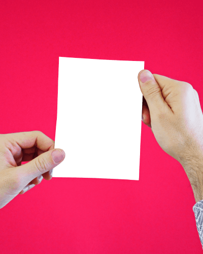 Man Holding Up A Flyer Mockup With Both Hands