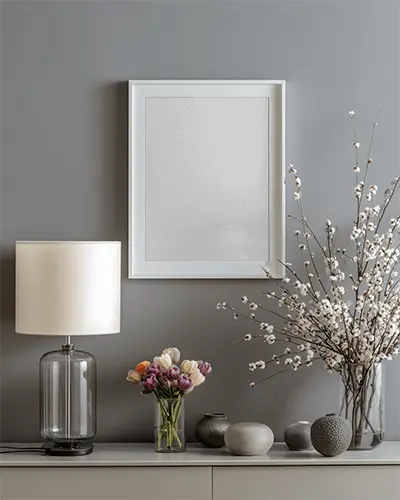 modern-wall-frame-mockup-with-elegant-table-lamp-and-floral-vase-arrangement-for-decor