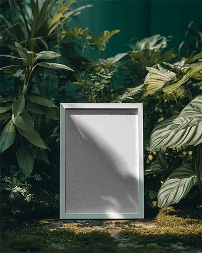 Minimalistic Frame Mockup Surrounded By Lush Leaves On Soft Ground For Creative Users