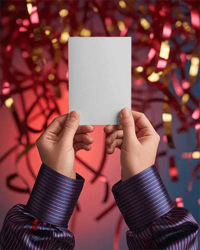 Person Holding Blank Card Mockup Over Festive Background With Streamers For New Year