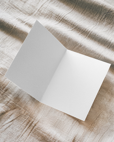 Soft Textured Bifold Greeting Card Mockup On Natural Fabric With Subtle Lighting Perfect For Invitation Or Personalized Message Designs