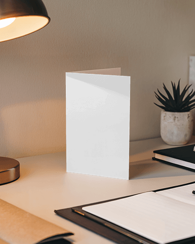 Standing Greeting Card Mockup On Modern Desk With Warm Lamp Light Notebooks And Succulent Cozy Workspace Vibe