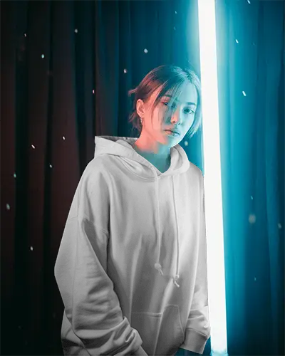 Elegant Studio Hoodie Mockup Female Model Standing In Front Of Curtained Background In Soft Light