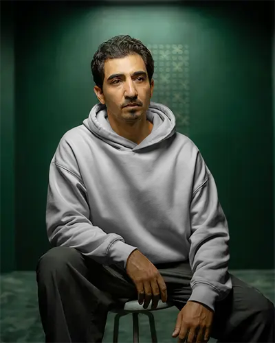 comfortable-relaxed-fit-hoodie-mockup-for-men-sitting-casual-style-studio-shoot