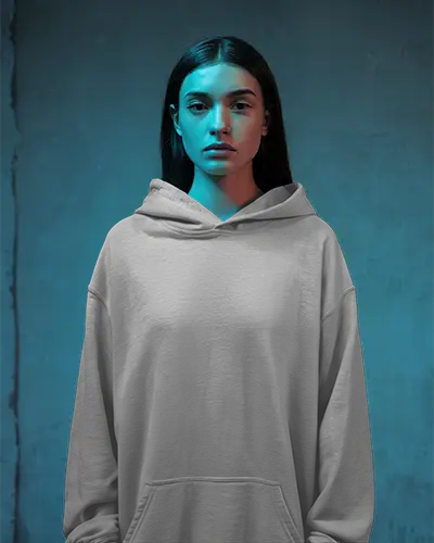 neon-blue-lit-hoodie-mockup-female-model-front-facing-minimal-expression-moody-studio-setting