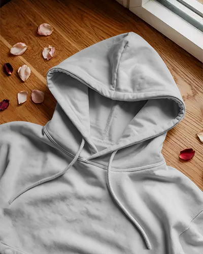 flat-lay-hoodie-mockup-on-wooden-floor-rose-petals-around-casual-minimal-styled-product-display