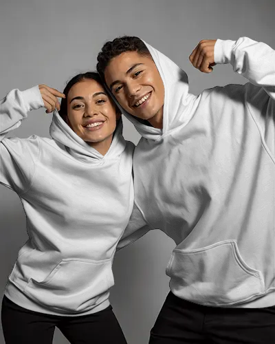 Playful Couple Hoodie Mockup Showing Joyful Expressions In Studio With Modern Casual Style
