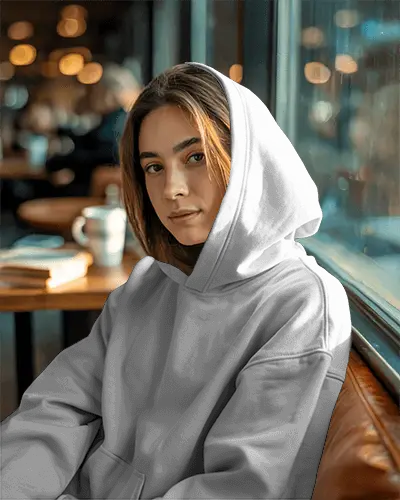 Stylish Hoodie Mockup Woman Sitting By Window In Coffee Shop With Golden Hour Light