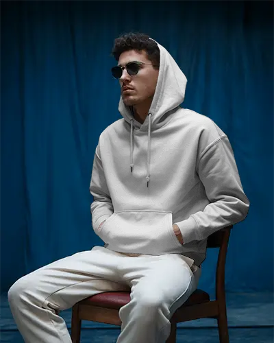 Stylish Male Hoodie Mockup In Dark Studio Setting With Modern Blue Backdrop And Attitude