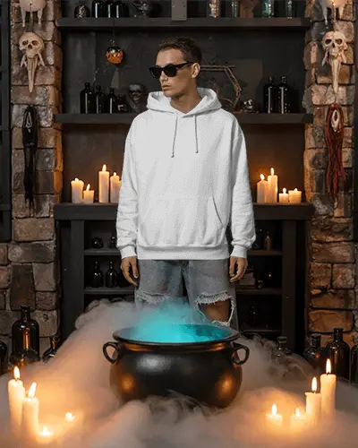Edgy Halloween Mockup With Casual Fashion Standing Near A Mist Covered Witchs Cauldron