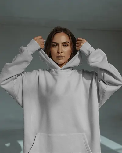 Confident Female Hoodie Mockup Model Lifting Hood In Moody Natural Light Setting