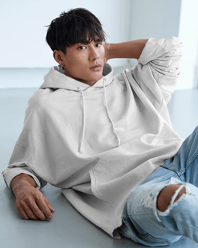 Relaxed Fit Hoodie Mockup Male Model Leaning Back In Bright Room Casual And Trendy Look