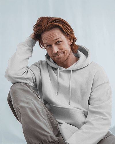 Creative Typography Hoodie Mockup Casual Male Model In Relaxed Pose Wearing Vibrant Graphic Statement Piece