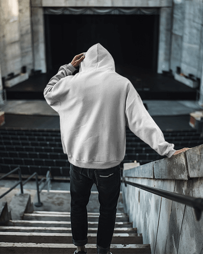 Gritty Cityscape Hoodie Mockup Male Model With Haunting Horror Design In Dystopian Backdrop