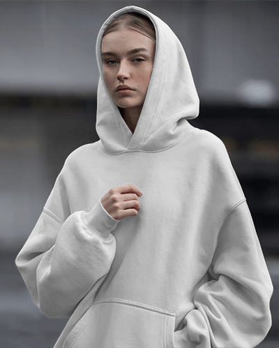 Moody Streetwear Hoodie Mockup Female Model In Oversized Hoodie With Intense Expression Urban Gray Backdrop Edgy And Modern Vibe