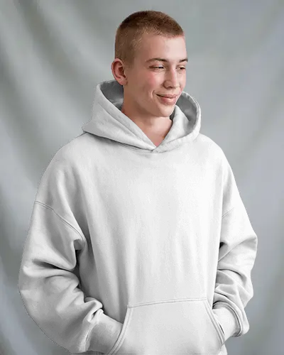 Relaxed Hoodie Mockup With Young Male Model Smiling And Looking Down In Soft Grey Studio Background