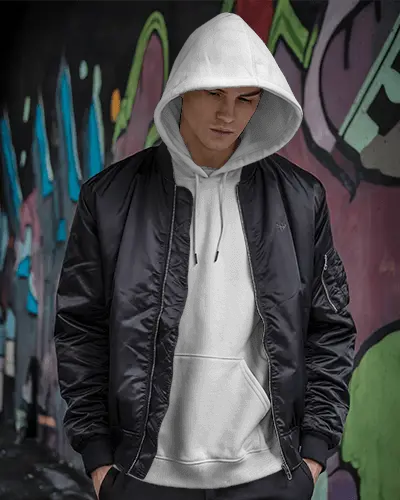 Urban Streetwear Hoodie Mockup With Male Model In Bomber Jacket And White Hoodie Against Graffiti Wall