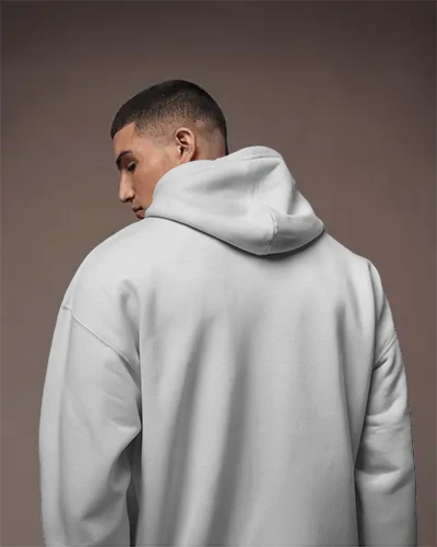 Soft Shadow Hoodie Mockup Apparel On Male Model Against Muted Studio Background