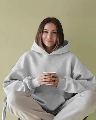 Peaceful Vibe Hoodie Mockup Female Model In Relaxed Fit Hoodie On Muted Green Backdrop