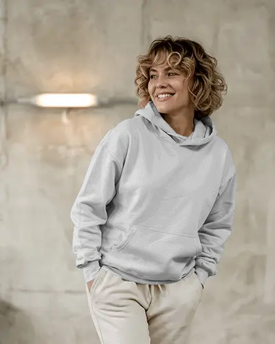 Cozy Studio Hoodie Mockup Woman Smiling In Soft Grey Background With Warm Light