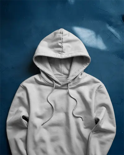 Laid Flat White Hoodie Mockup On Deep Blue Textured Background With Natural Light Soft Modern Style