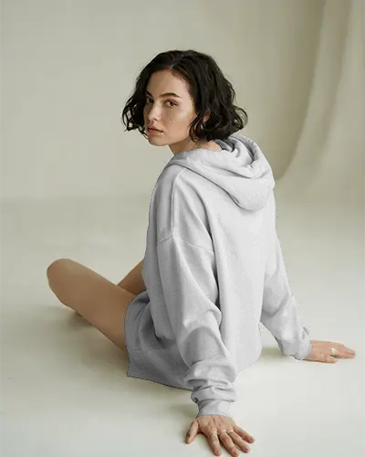 Casual Woman Sitting In Studio With Hoodie Mockup For Custom Design