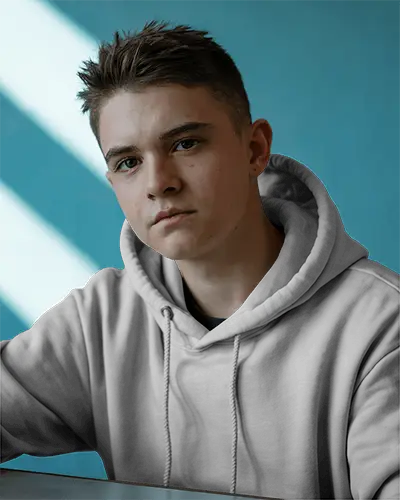 Casual Interior Hoodie Mockup Young Male Model Facing Camera With Natural Window Light And Teal Wall 0591