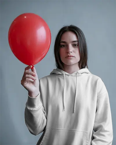 Bold Expression Hoodie Mockup Female Model Holding Red Balloon Against Muted Grey Backdrop In Contrast Light 0592