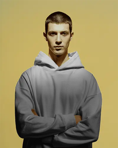 Bold Studio Hoodie Mockup Male Model Crossing Arms With Confident Expression Against Warm Yellow Background 0595