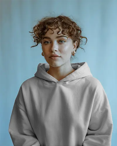 Front Facing Hoodie Mockup Young Female Model With Curly Hair In Soft Lighting Against Cool Blue Background 0596