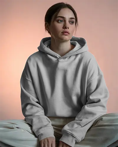 Cozy Indoor Hoodie Mockup Female Model Sitting Cross Legged In Soft Light Against Blush Gradient Background 0600