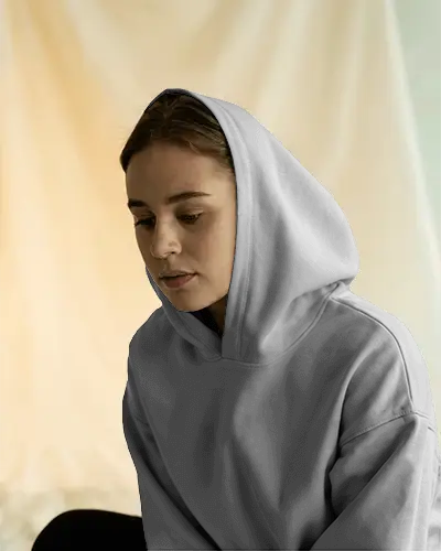 Cozy Indoor Hoodie Mockup Featuring Thoughtful Expression Model In Soft Natural Light For Calm Fashion Campaign