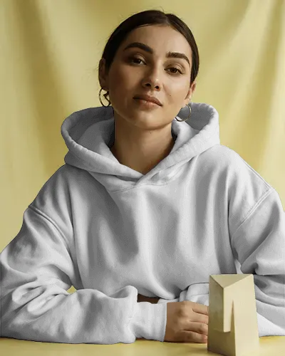 Lifestyle Hoodie Mockup Model With Geometric Prop On Yellow Backdrop