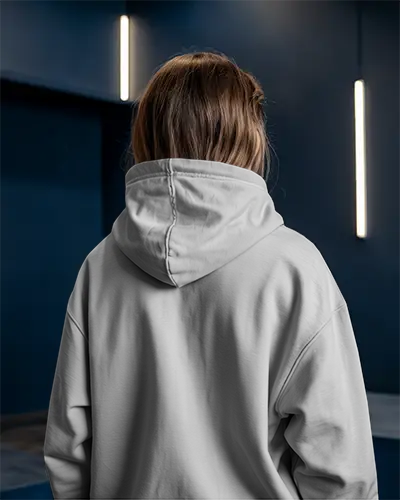 Moody Interior Hoodie Mockup Female Model Back View Against Deep Blue Wall With Vertical Lights Urban Vibe