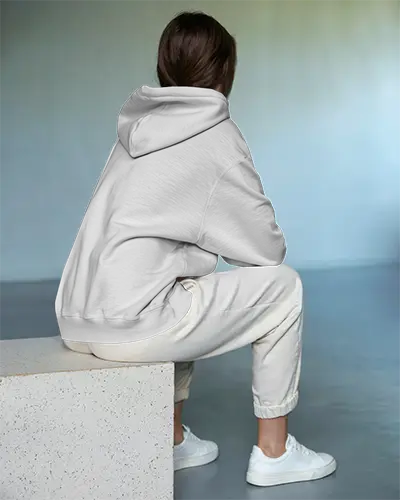 Seated Back View Hoodie Mockup Female Model In White Hoodie And Casual Sweatpantsv