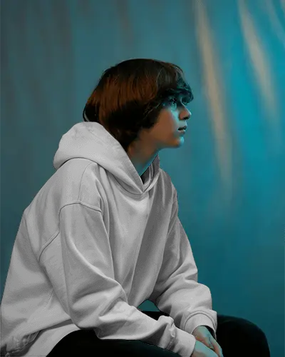 Contemplative Boy Hoodie Mockup Soft Blue Tones And Shadowed Portrait Scene