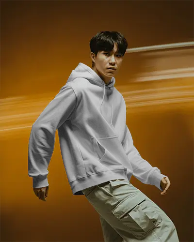 Bold Motion Hoodie Mockup Male Model In White Hoodie With Cargo Pants Against Orange Blur Background Dynamic Style 0706