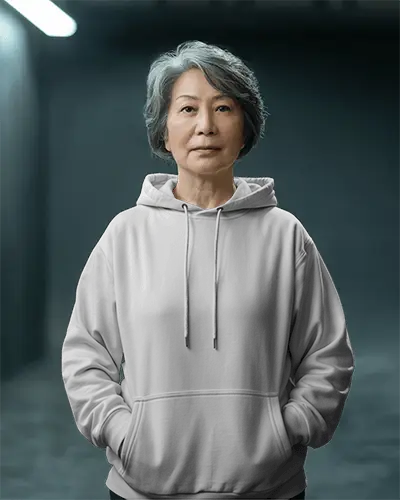 Studio Portrait White Hoodie Mockup Senior Asian Woman Facing Forward In Dark Background With Soft Top Lighting 0709